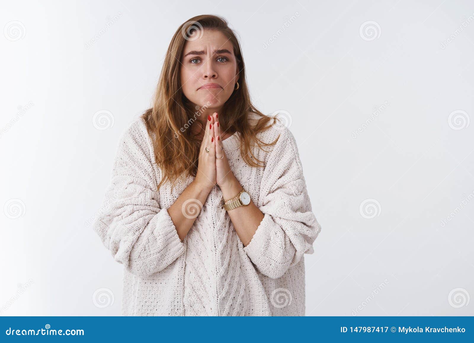 girl acting silly miserable supplicating pressing palms together pray pursing lips asking please help lend money begging