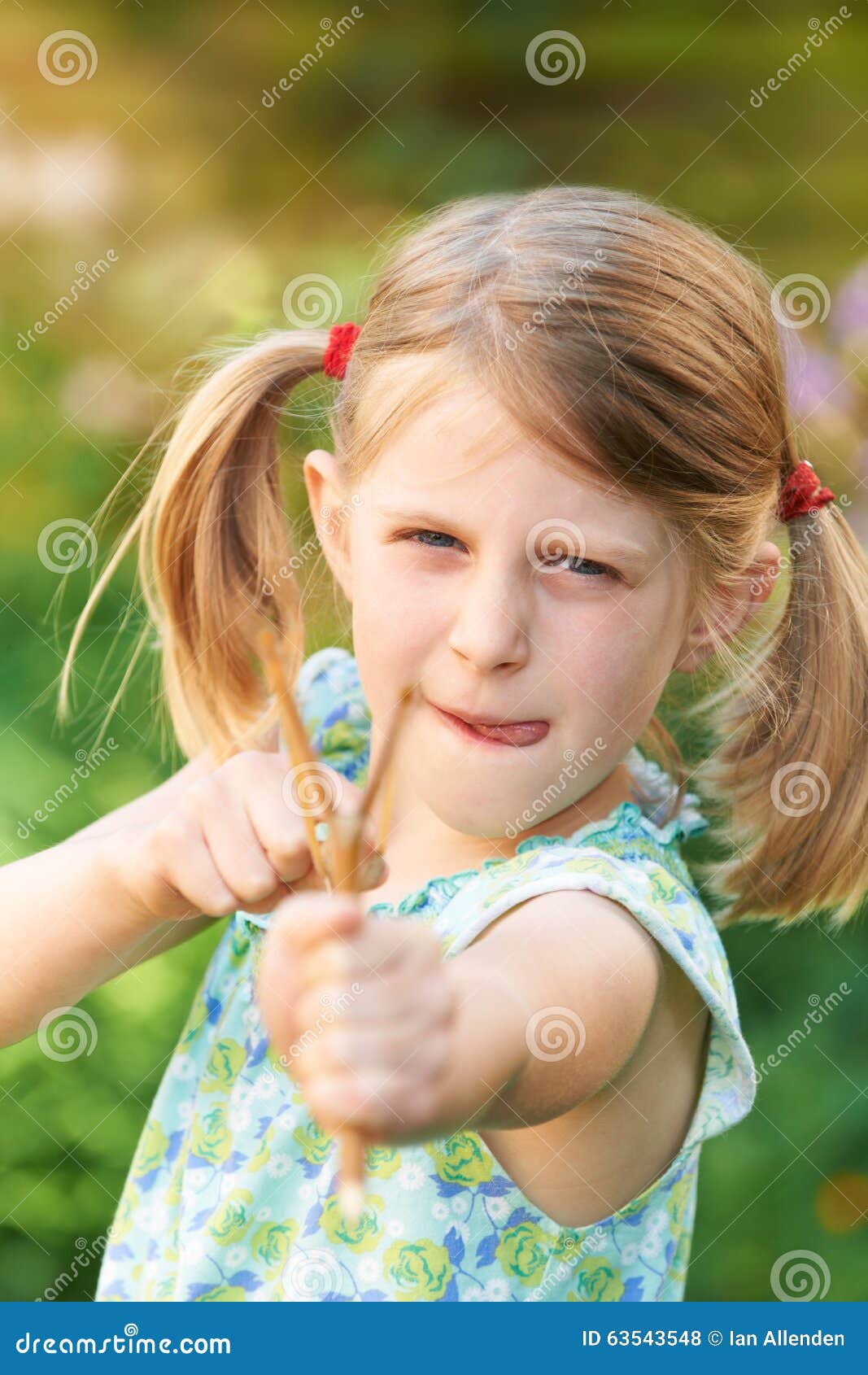 Girl Aiming Slingshot at Camera Stock Photo Image of camera, home