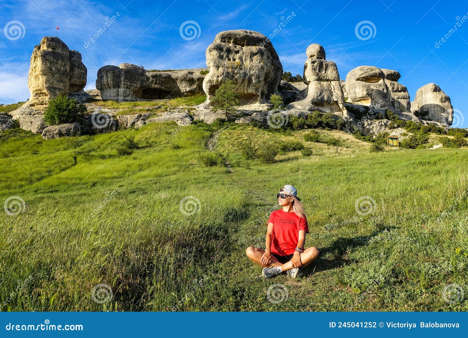 a girl on the background of a picturesque view of the bakhchisarai sphinxes in summer. bakhchisarai. may 2021. crimea.