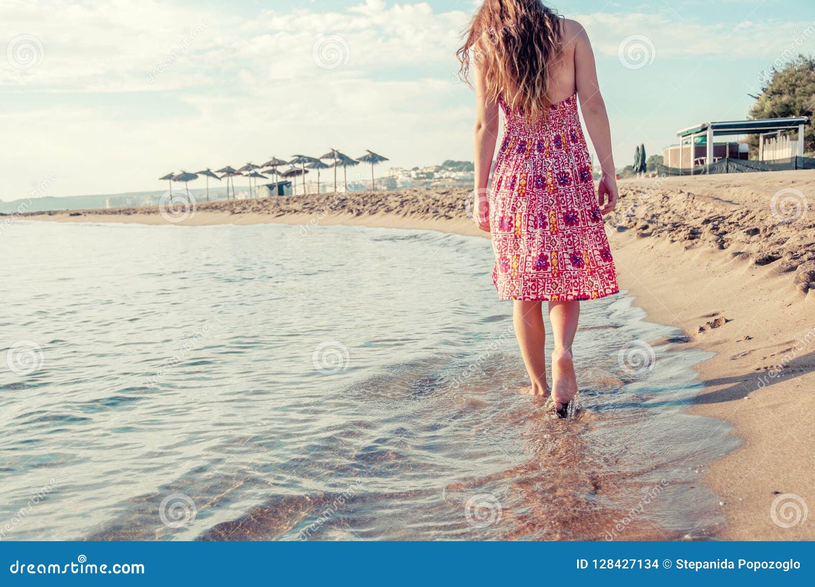 Woman Barefoot Hold Hat And Walking On Summer Along Wave 