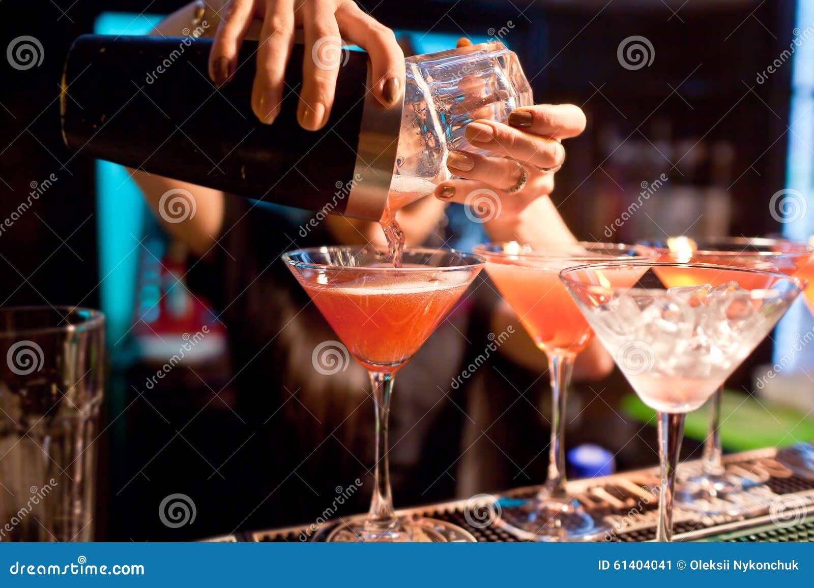 the girl bartender prepares a cocktail in the nightclub