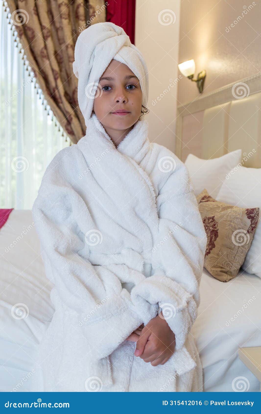 girl in a bathrobe with a towel on her head in a