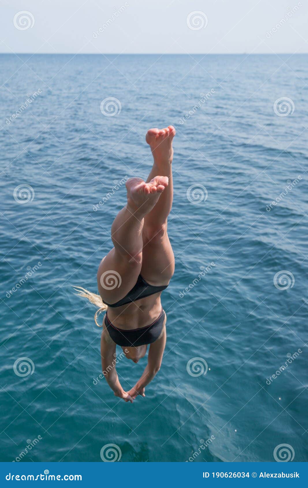 girl plunging into deep sea water
