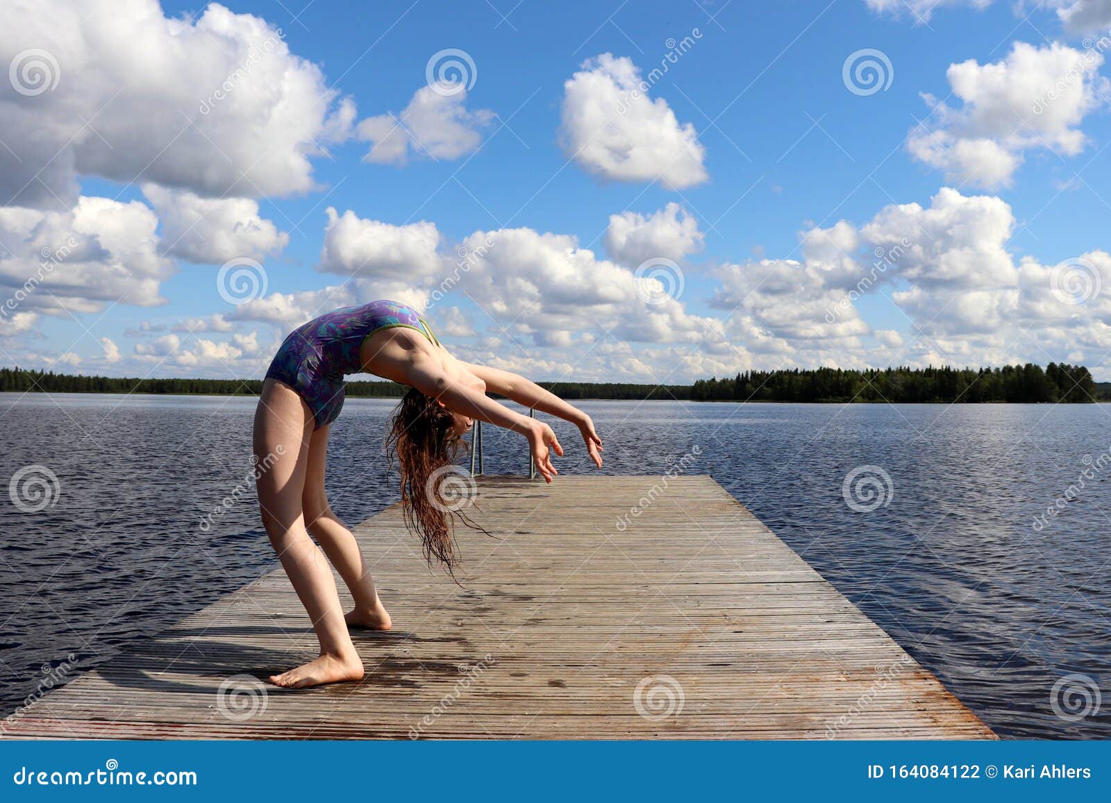 Girl Bending Over Backwards Into A Backbend At A Lake In Finland Stock