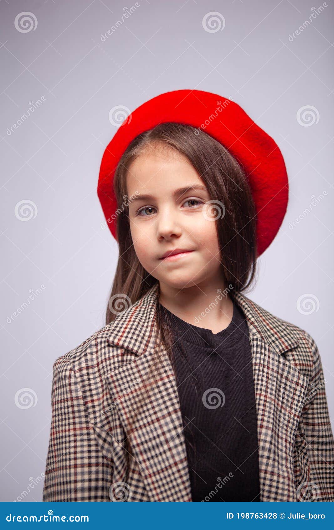 Girl in Beret and Coat with on a Light Gray Background Stock Photo