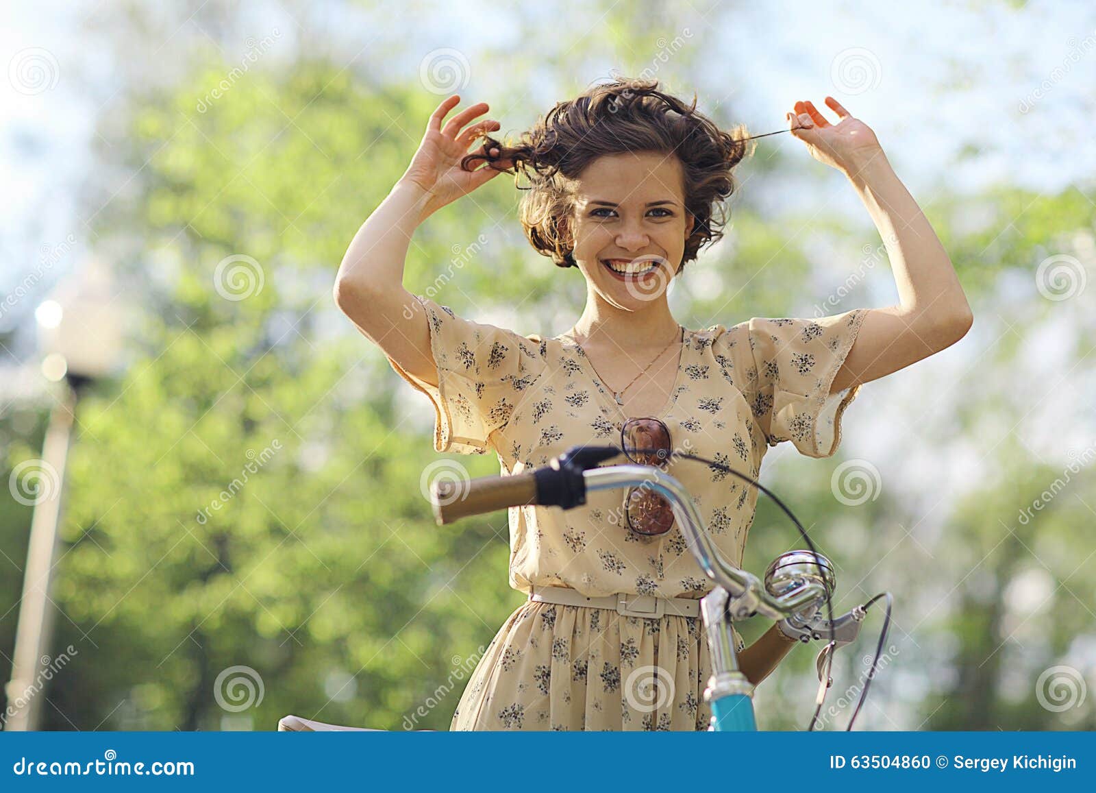 Girl on a bicycle in dress stock photo. Image of playing 63504860