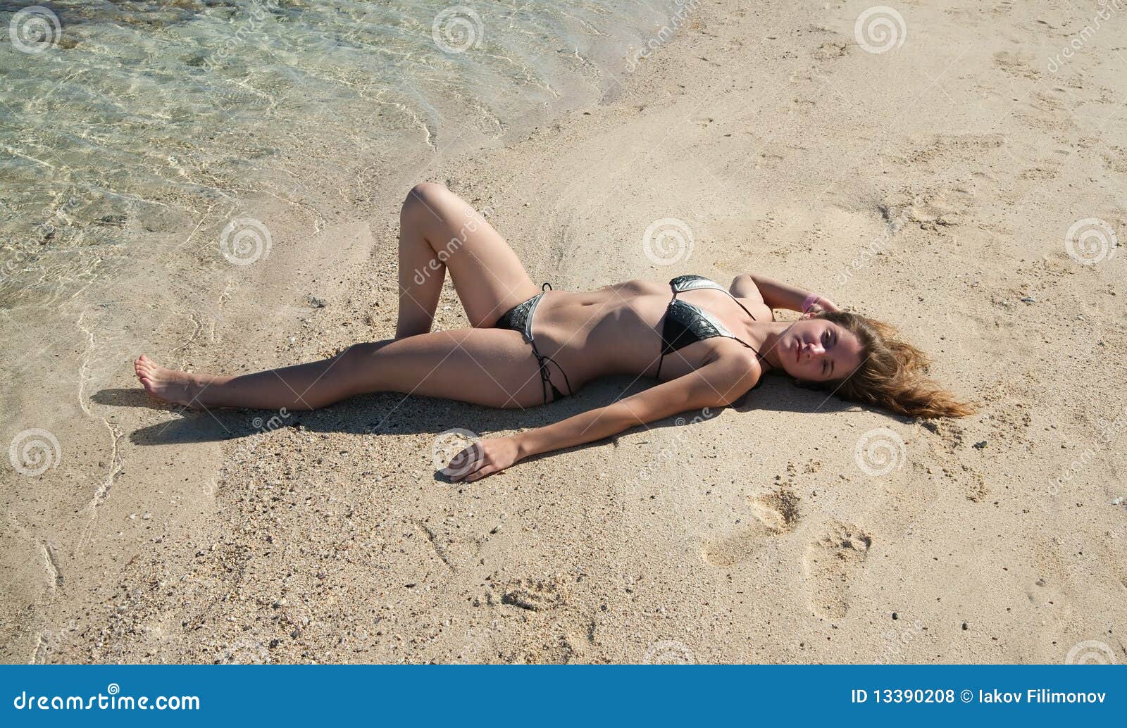 Girl in Bikini Sunbathing at Beach Stock Photo picture