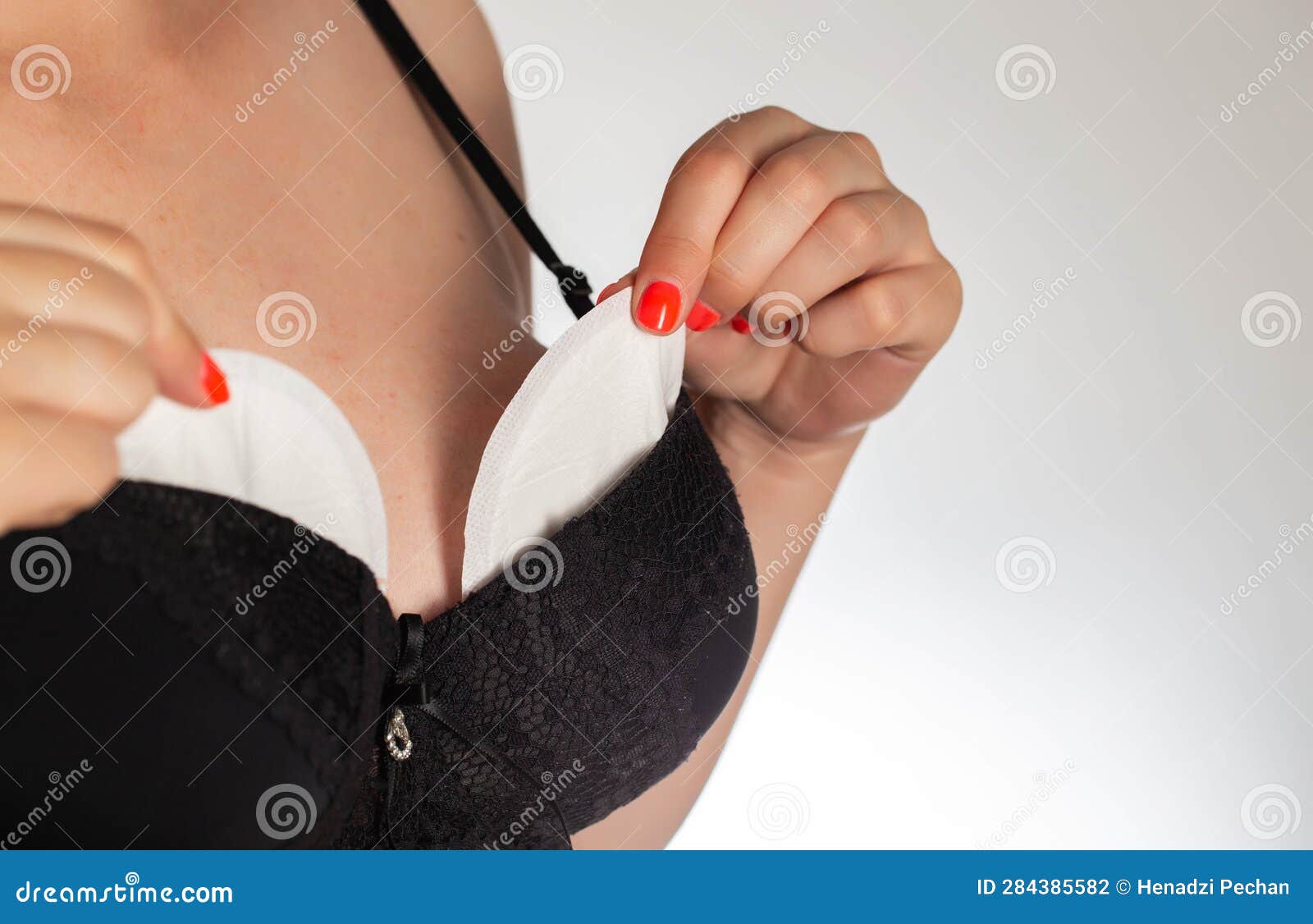 A Girl in a Black Bra Puts Pads from the Flow of Milk in Her Bra. Soft,  Hypoallergenic Breast Pads. Stock Photo - Image of bust, leakage: 284385582