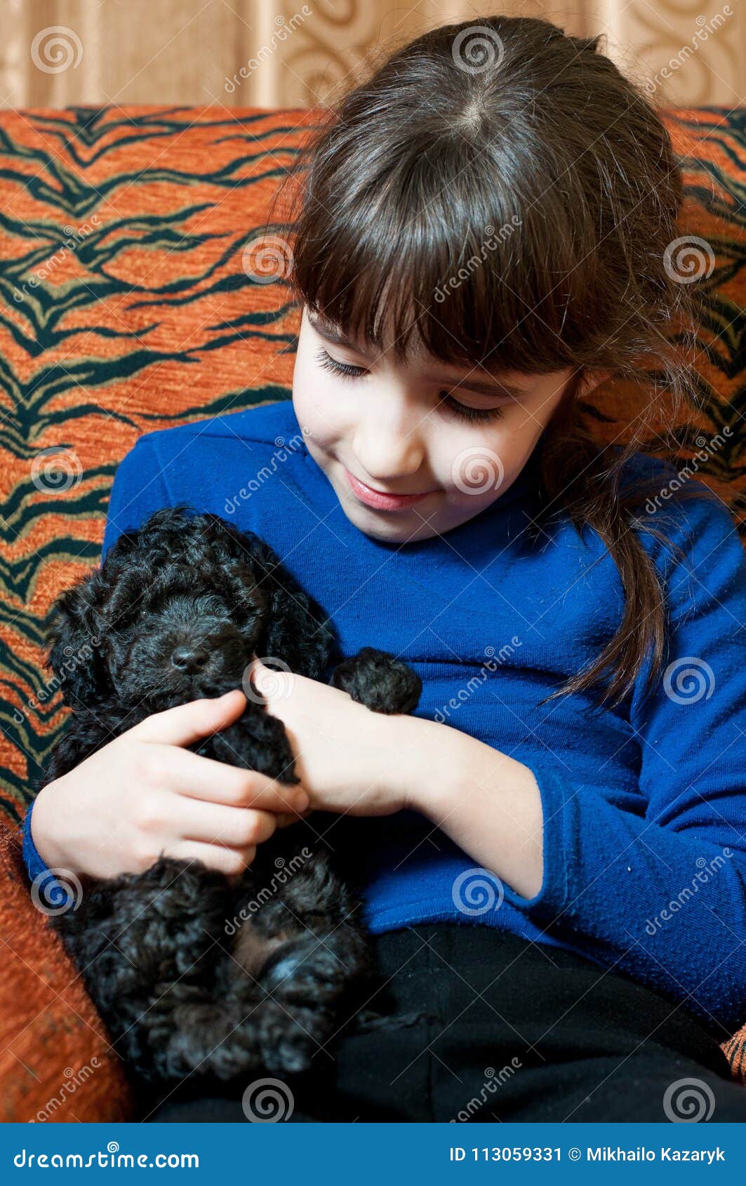 Girl with a black puppy stock image. Image of funny - 113059331
