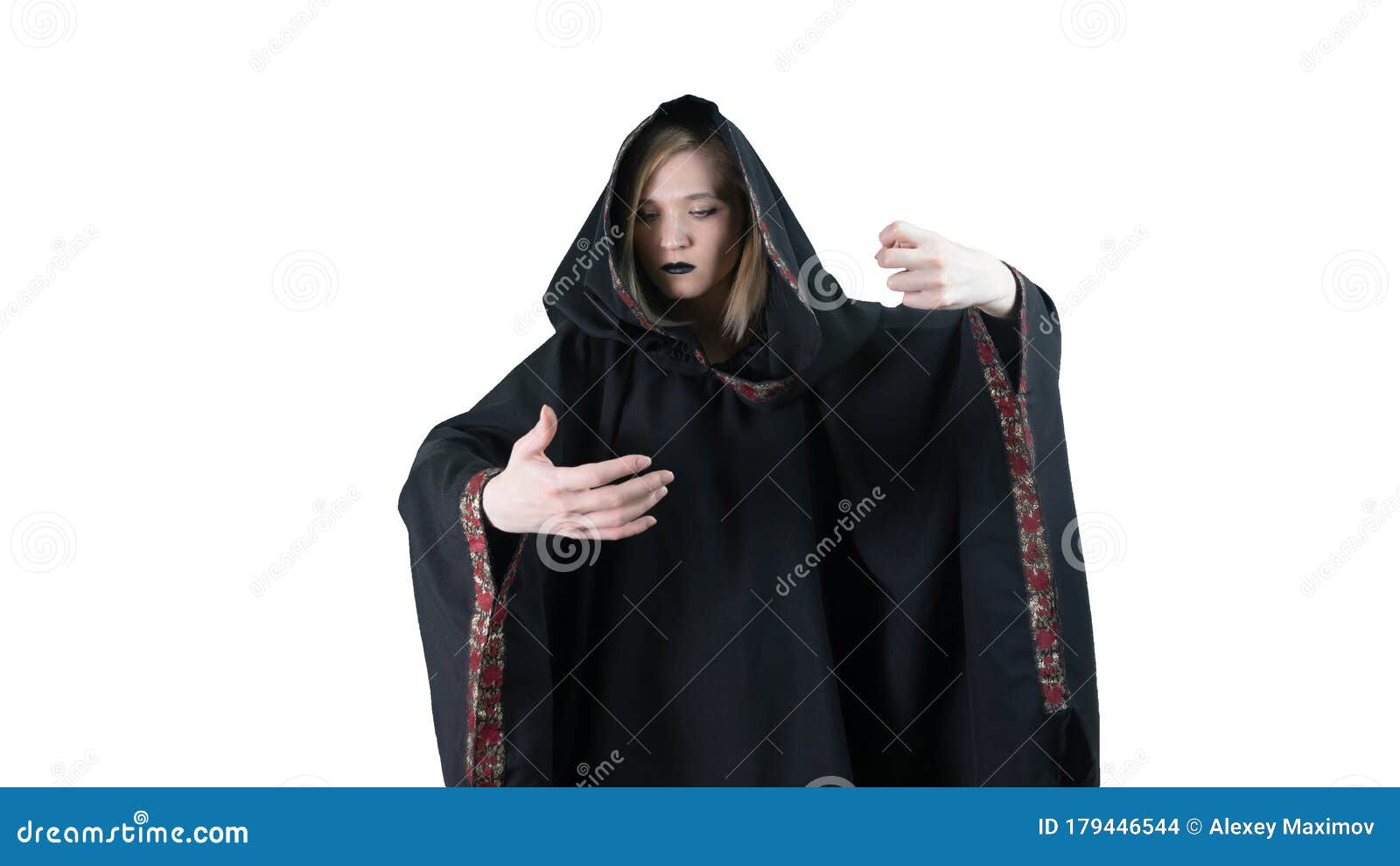 A Girl In A Black Robe, Making Magic Movements. On White Background