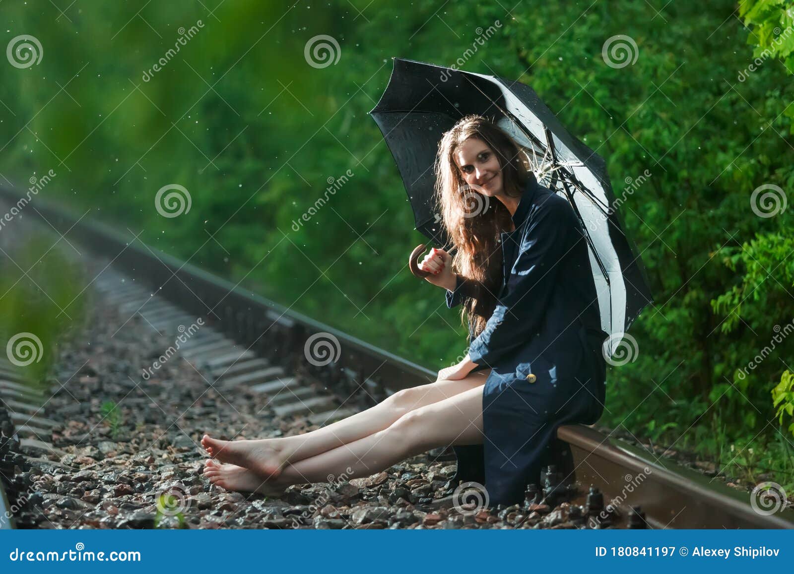 https://thumbs.dreamstime.com/z/girl-black-umbrella-railway-tracks-forest-its-raining-sitting-rails-her-hair-loose-smile-face-look-camera-180841197.jpg