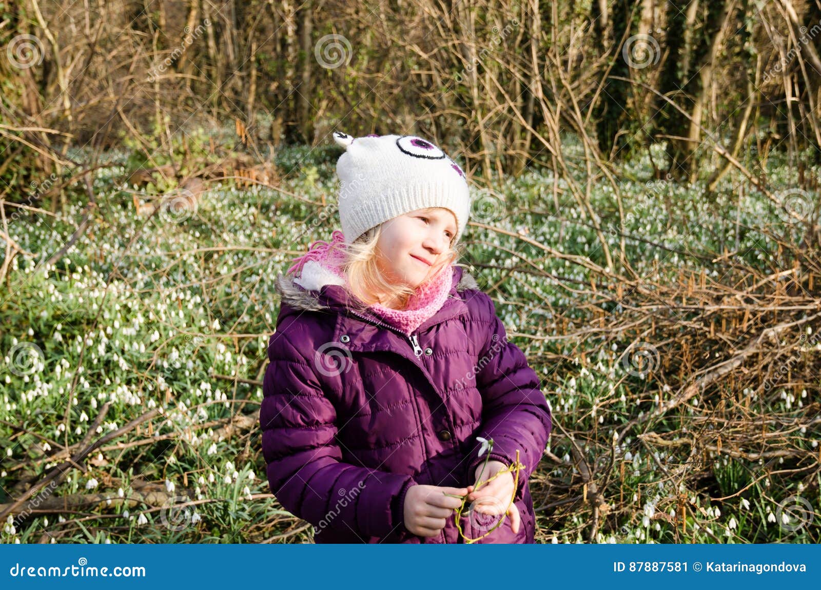 girl and blossoming white snowdrop