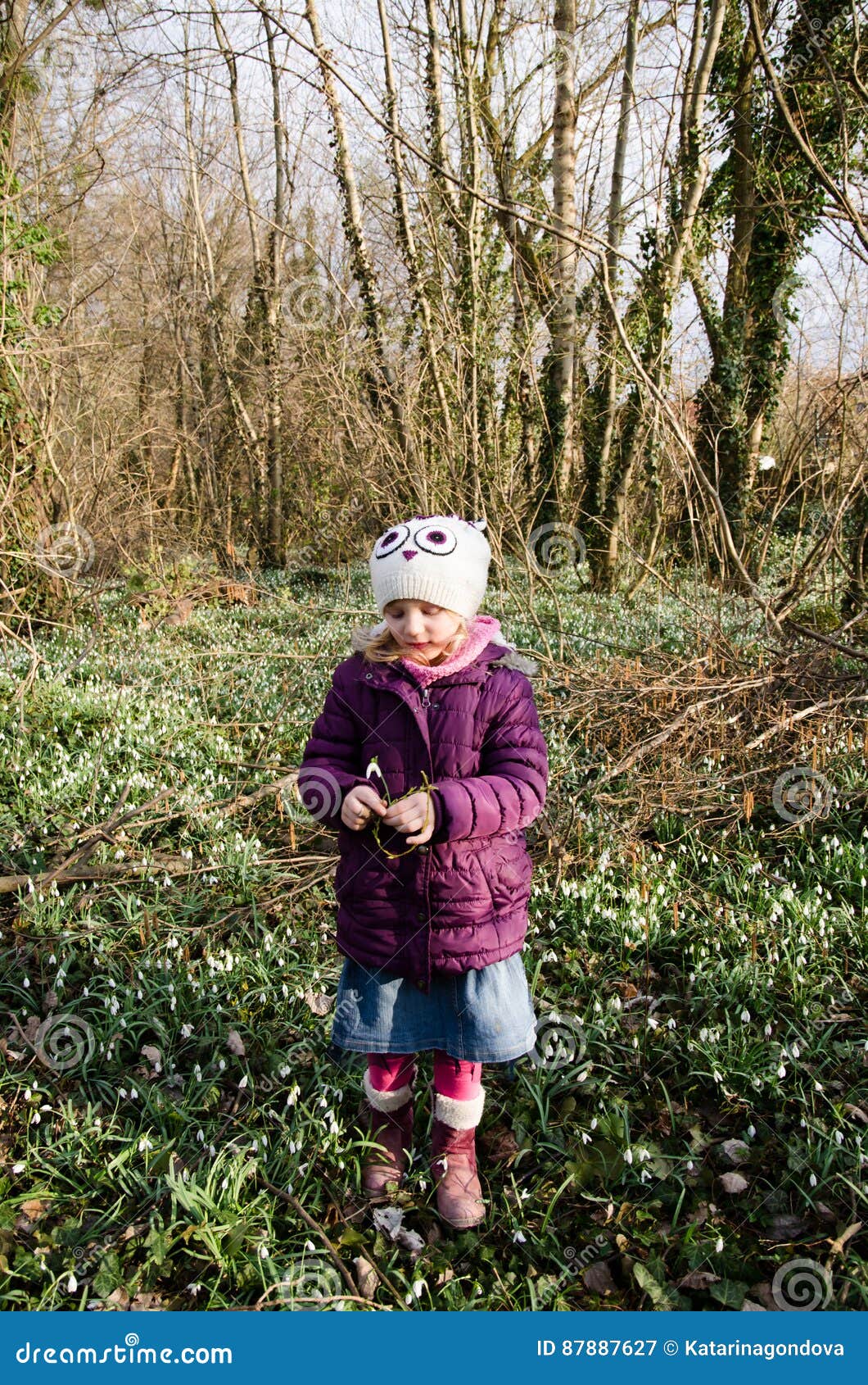 girl and blossoming white snowdrop