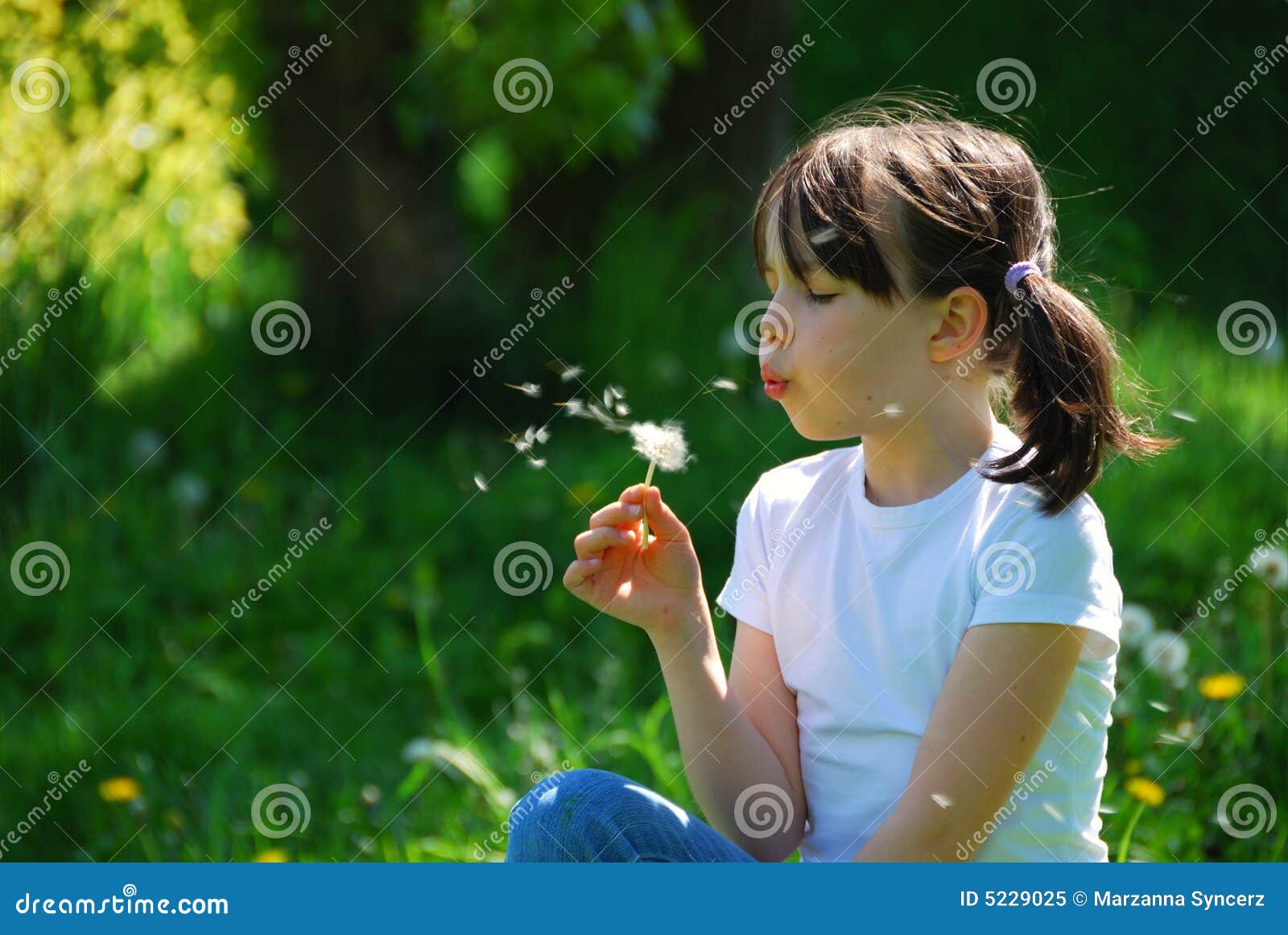 girl blowing dandelion