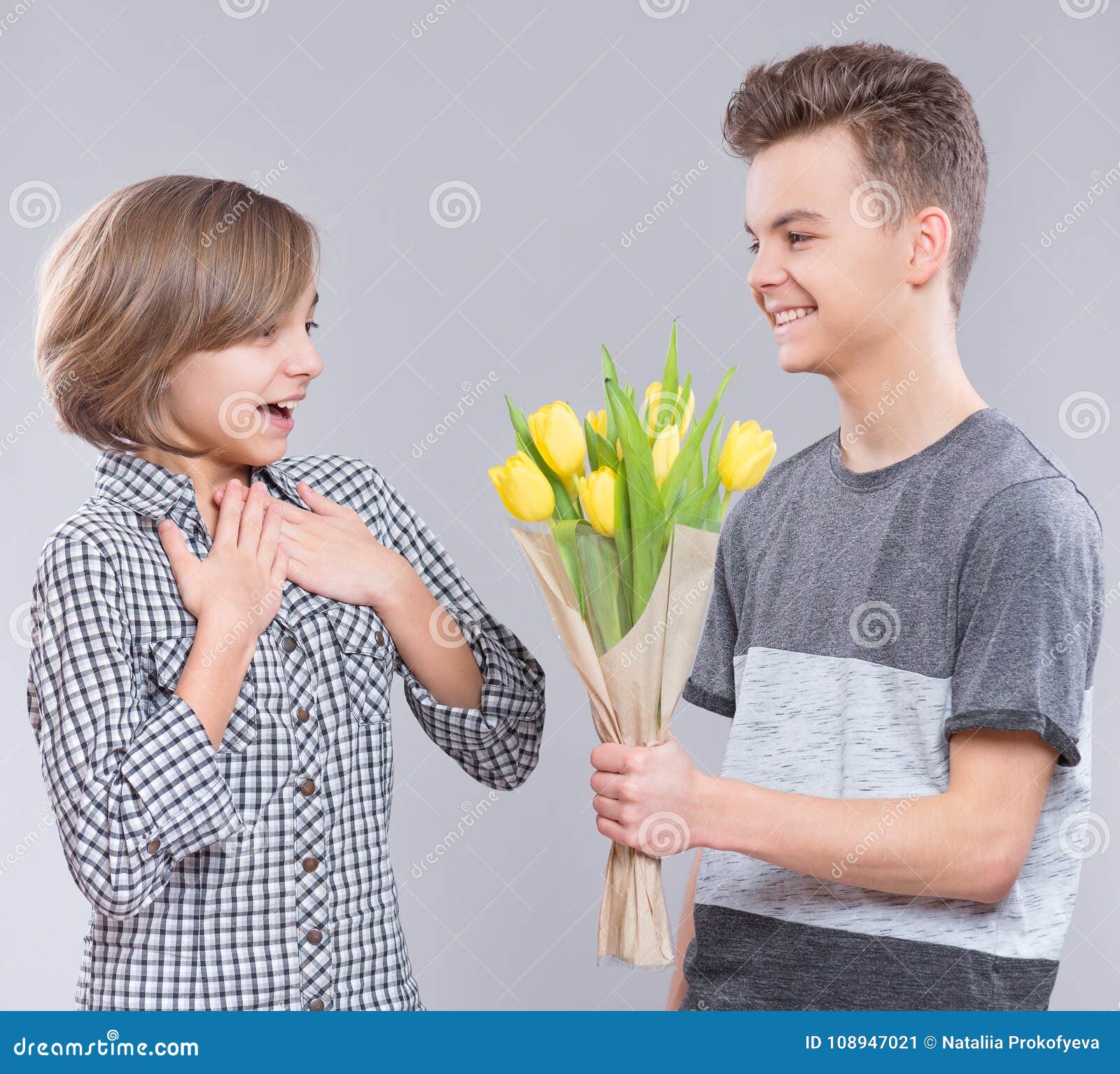 Girl and boy with flowers stock image pic