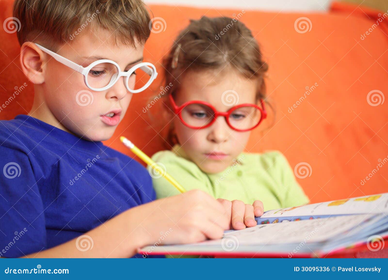 girl and boy intently doing homework