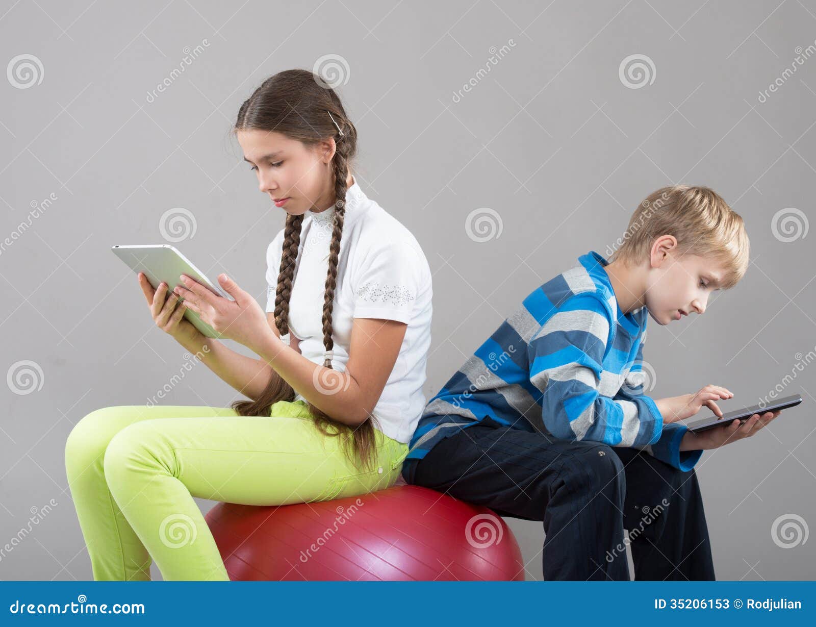 girl and boy looking at pad tablet pc screens
