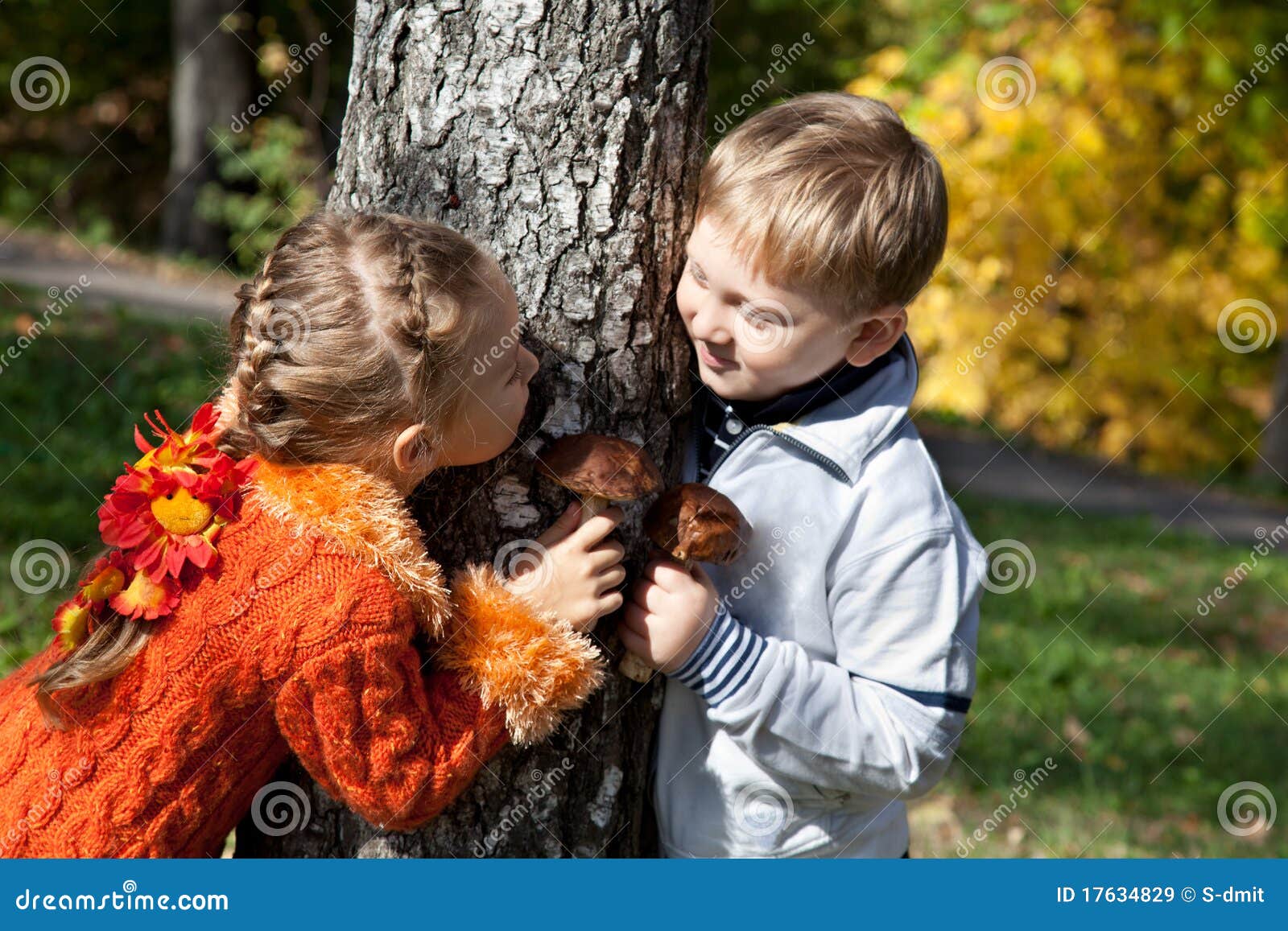 a girl and a boy are playing hide-and-seek