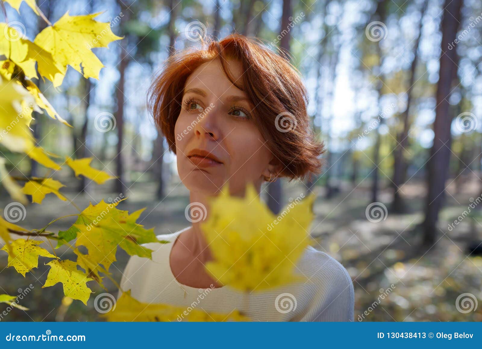 Girl with Brown Hair Stands Near Maple Branches with Yellow Leaves and ...