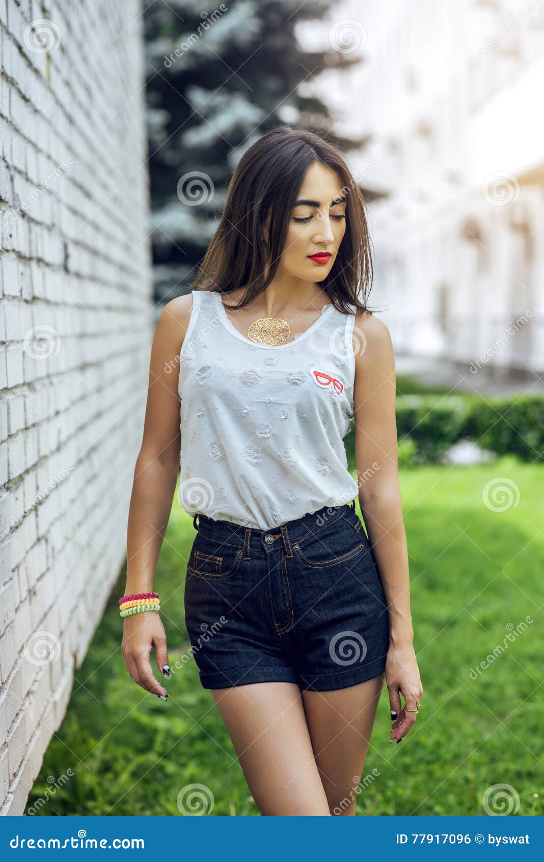 Girl Brunette in Summer in the Park with Resting in Shorts and White ...