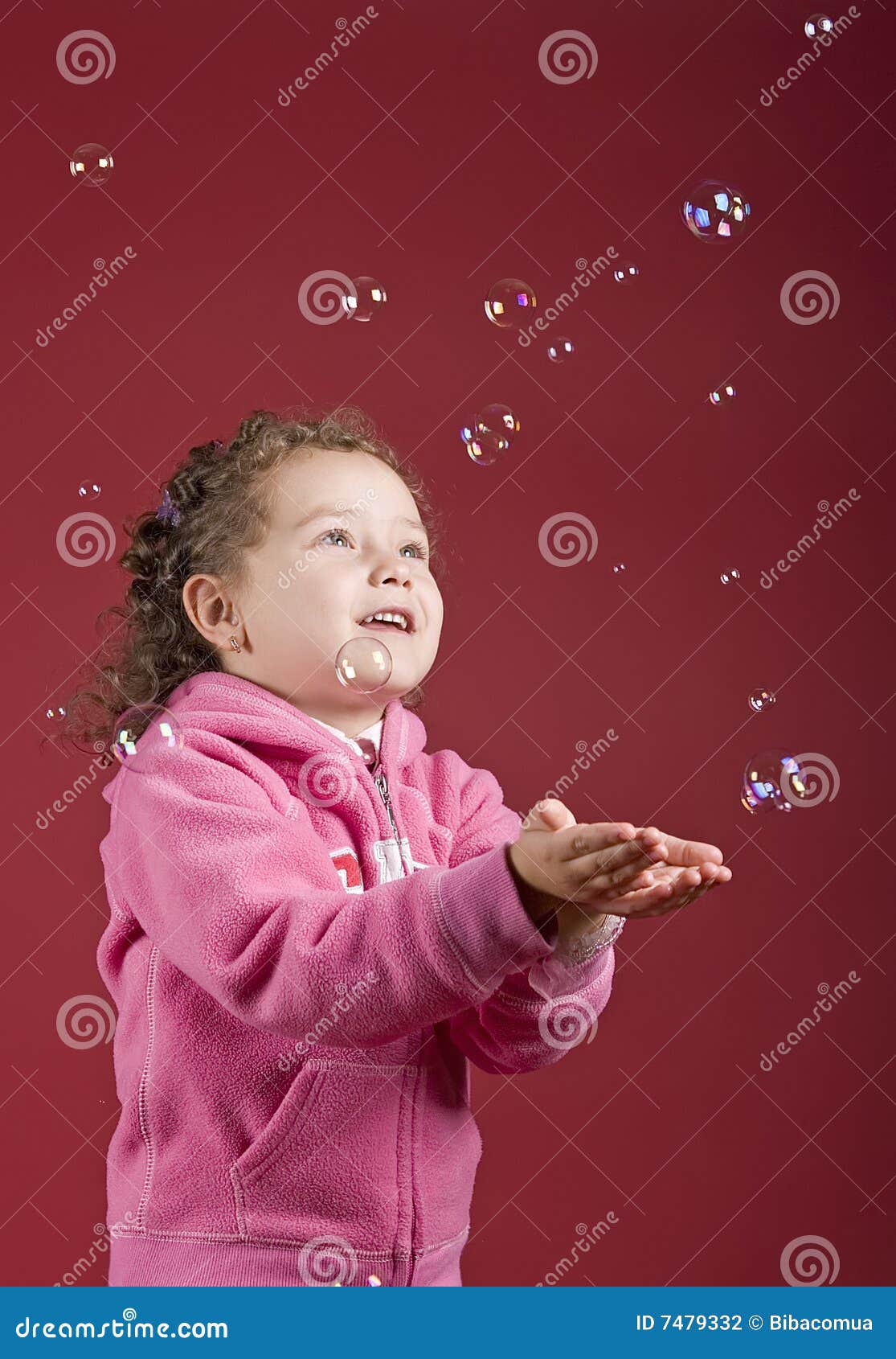 girl catching soap bubbles