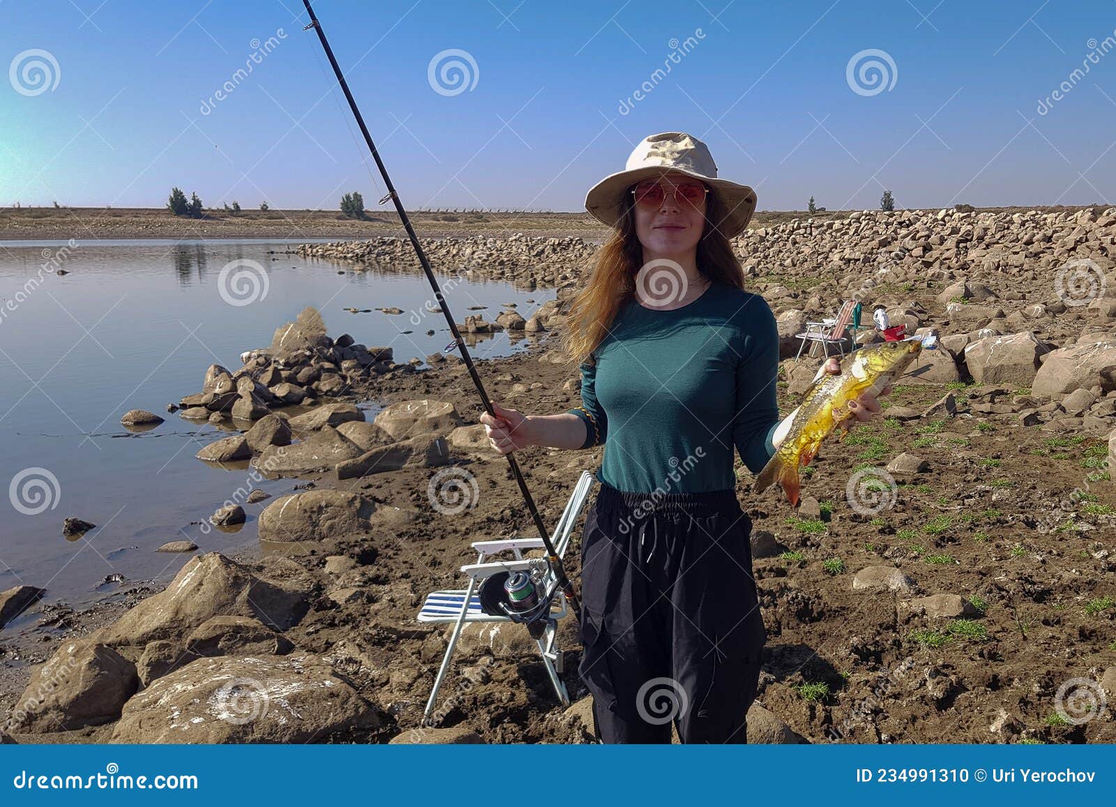 The Girl Caught a Fish on a Fishing Rod Stock Photo - Image of bite,  background: 234991310