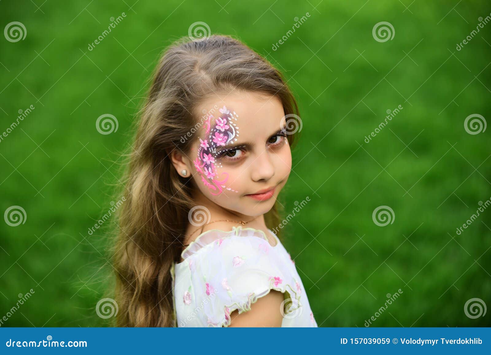 Girl child with fashionable art makeup, spring. Summer fashion, beauty salon. Hairdresser and hairstyle. Makeup and cosmetics, fashion look. Little girl with long hair, childhood and happiness.