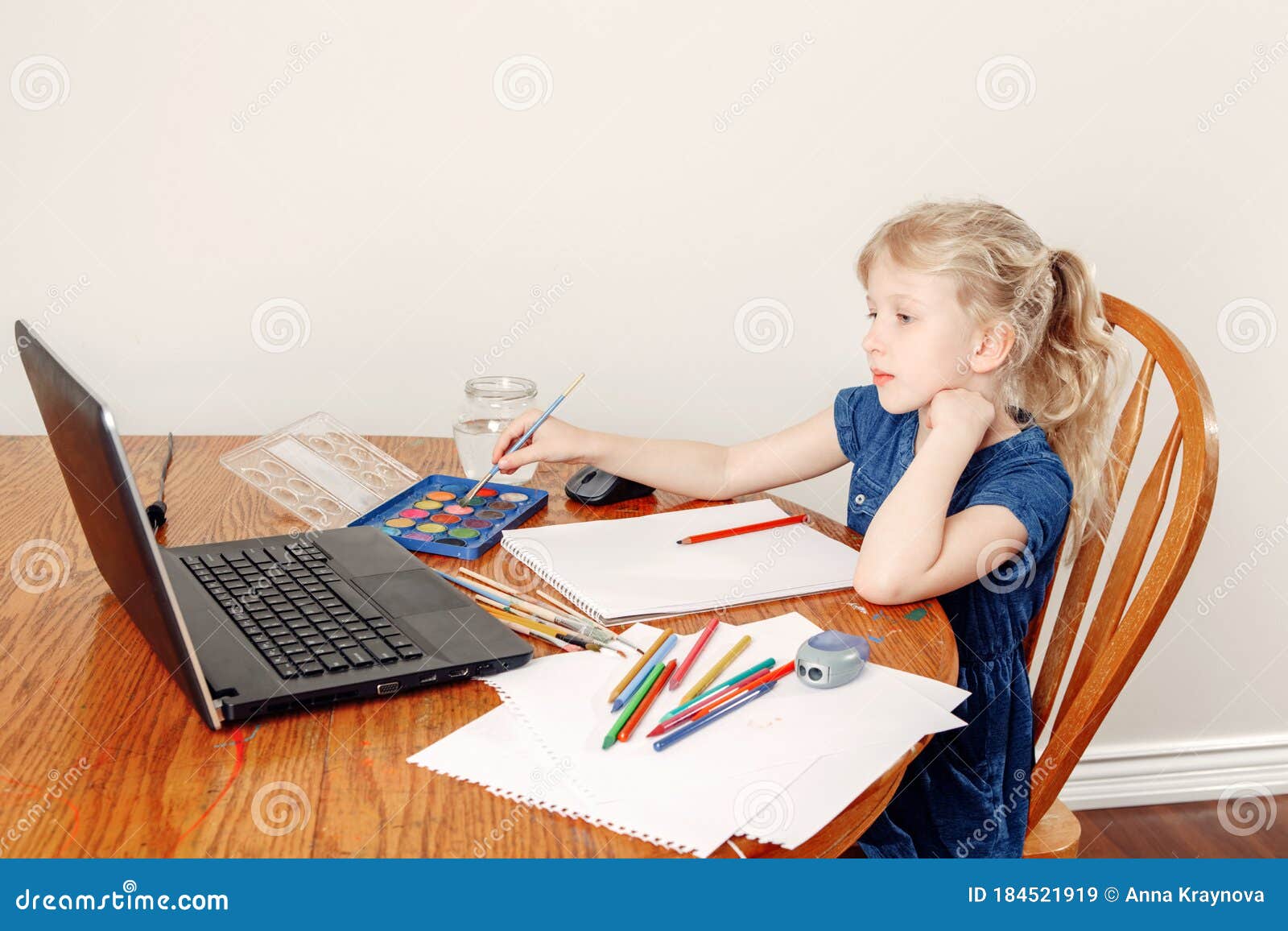 girl child learning art lesson online on laptop internet. virtual drawing painting class on video during self-isolation at home.