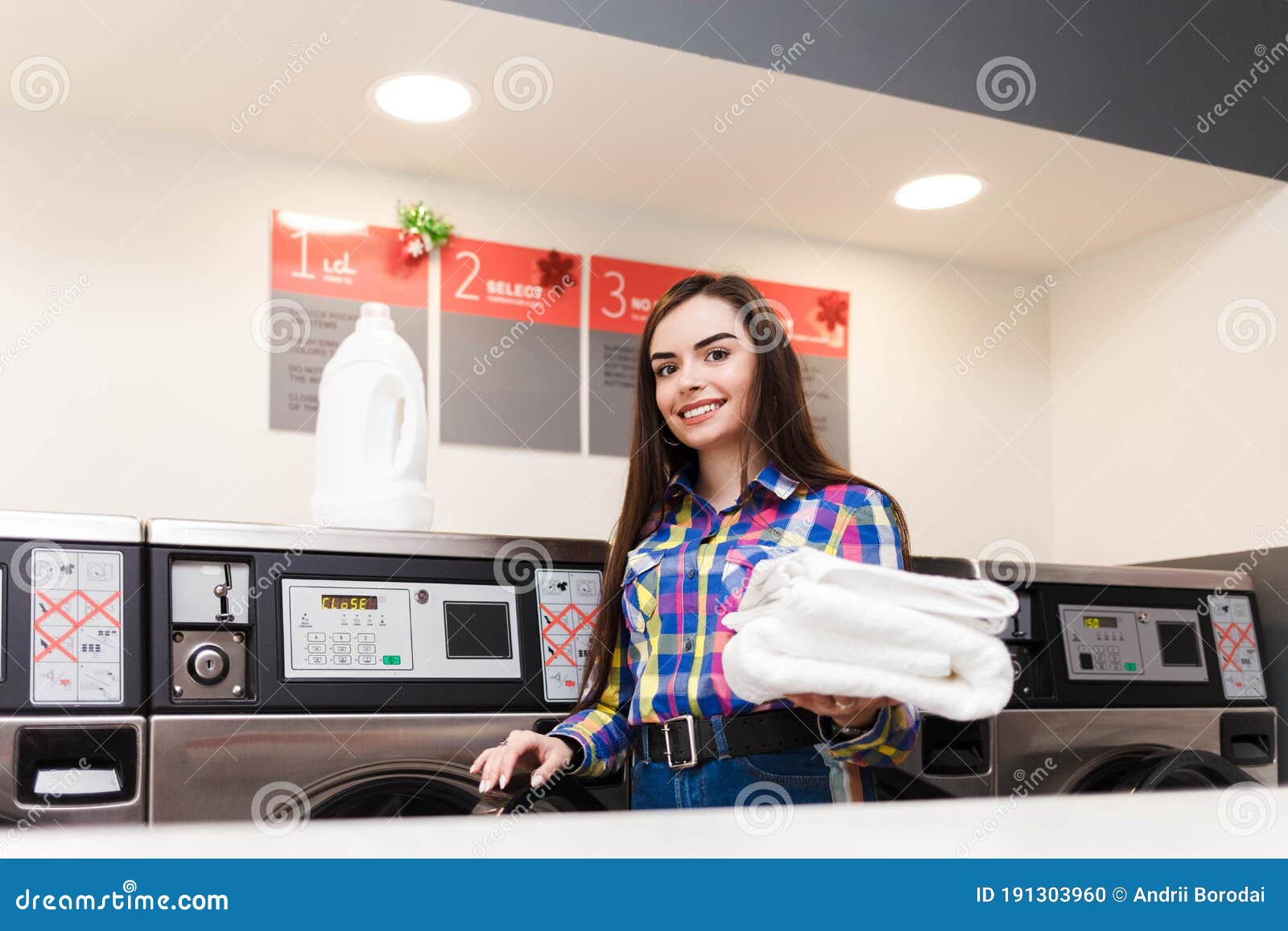 Girl with Clean White Towels Stands on the Background of Washing ...