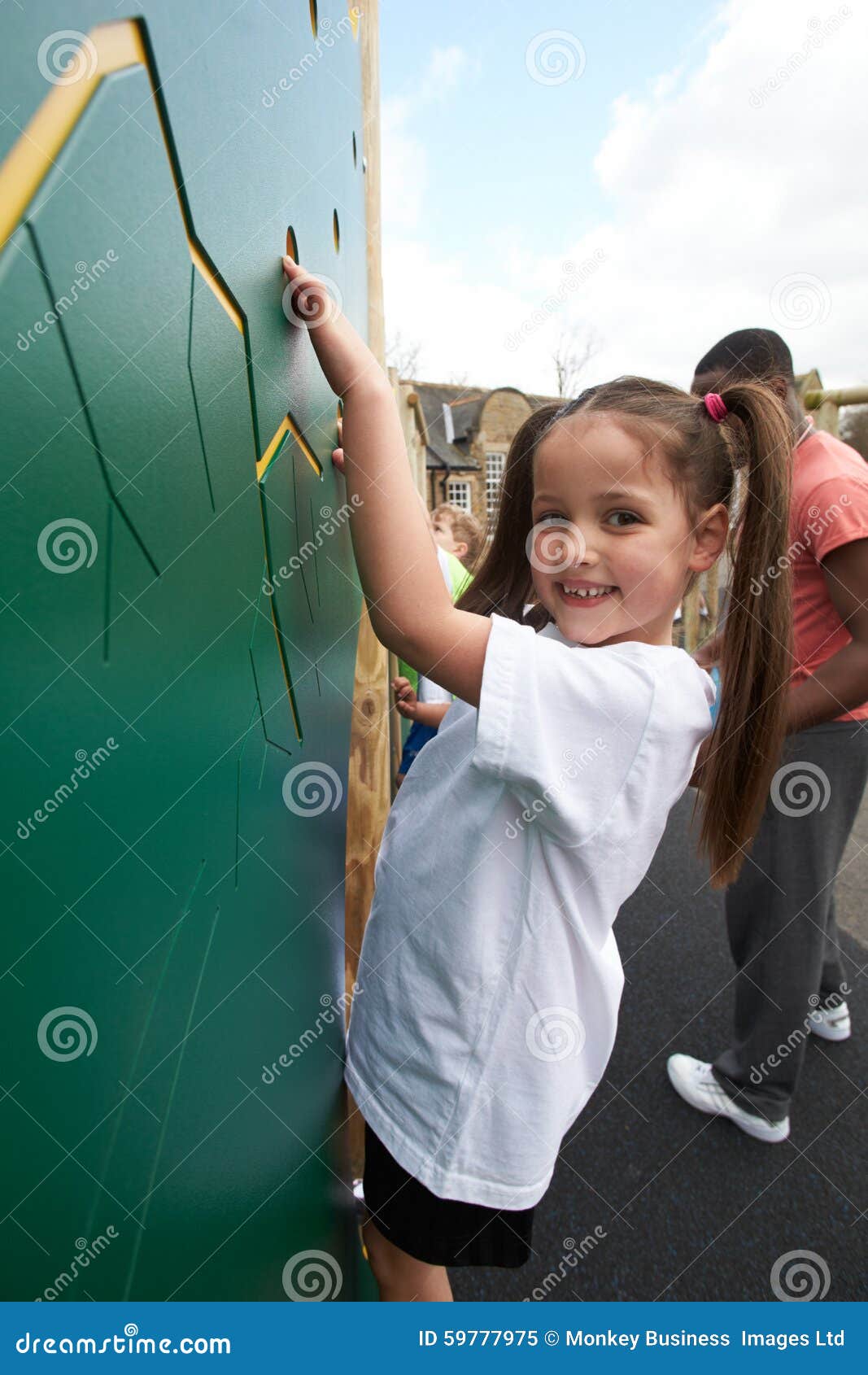 Girl on Climbing Wall in School Physical Education Class Stock Image