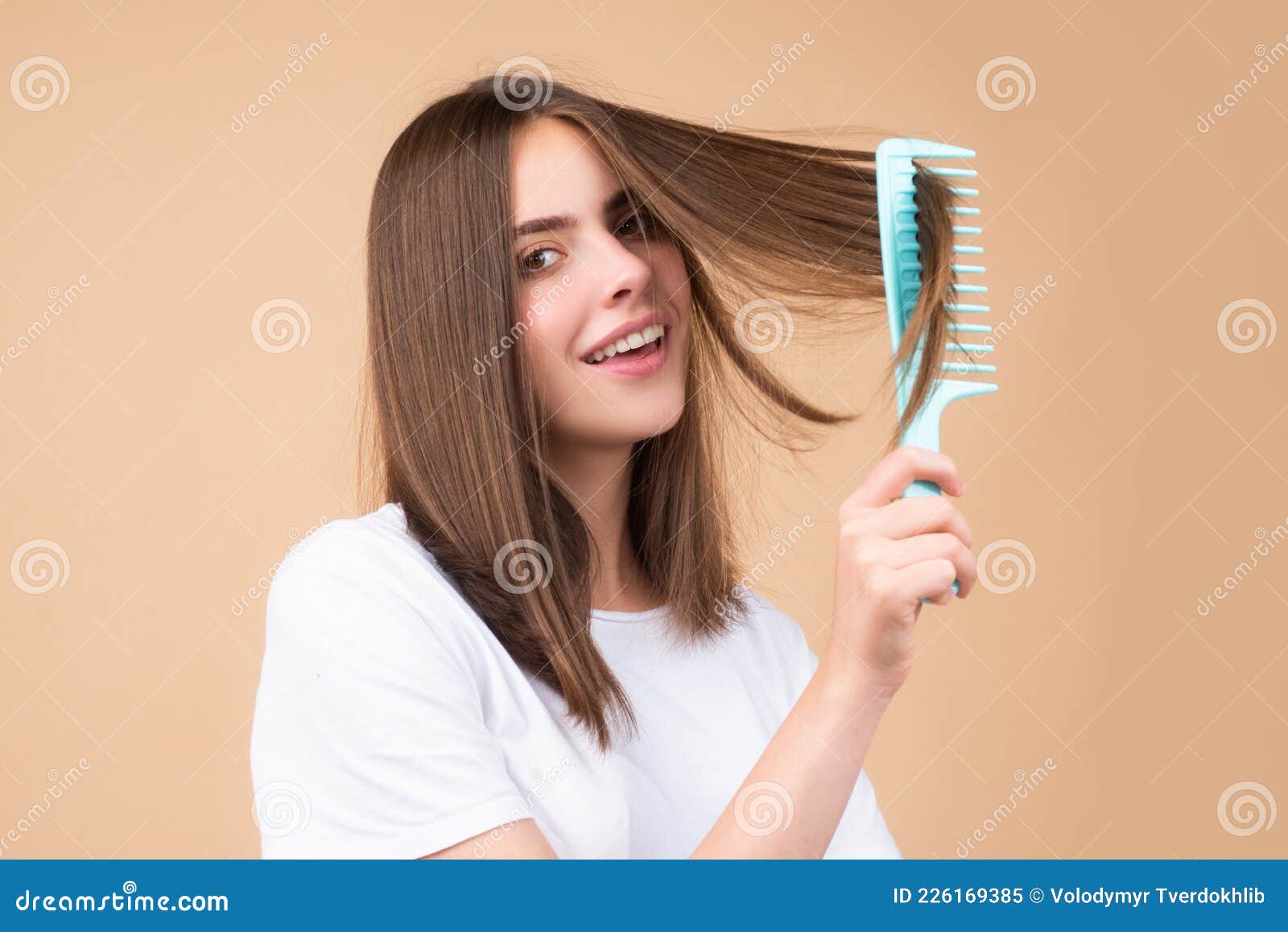 Girl Combing Hair. Beautiful Young Woman Holding Comb Straightened Hair ...