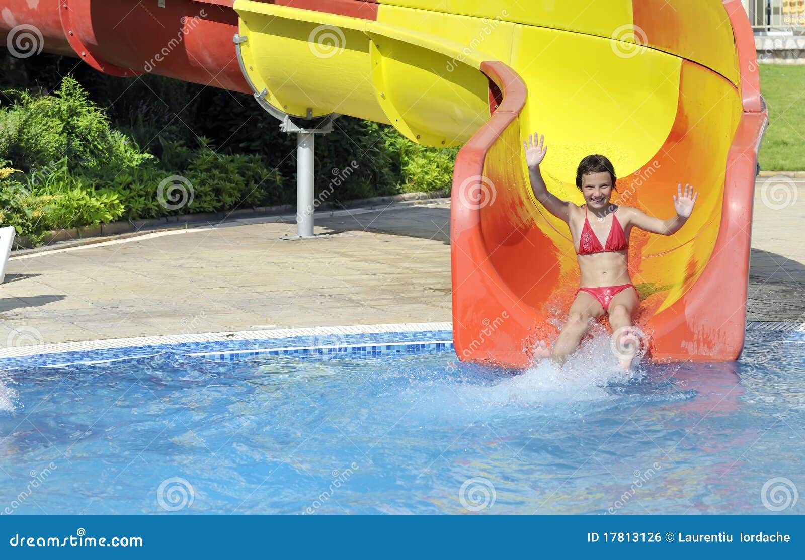 Girl Comes Down The Slide Into The Pool Stock Photo Image of water