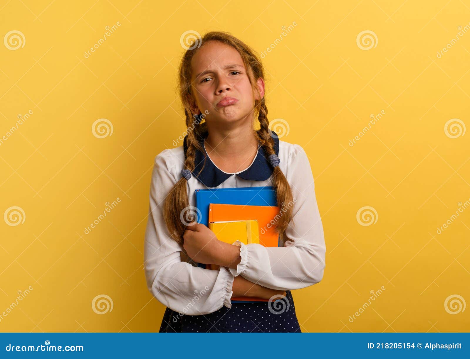 girl cries because he has a lot of school homework. emotional expression. yellow background