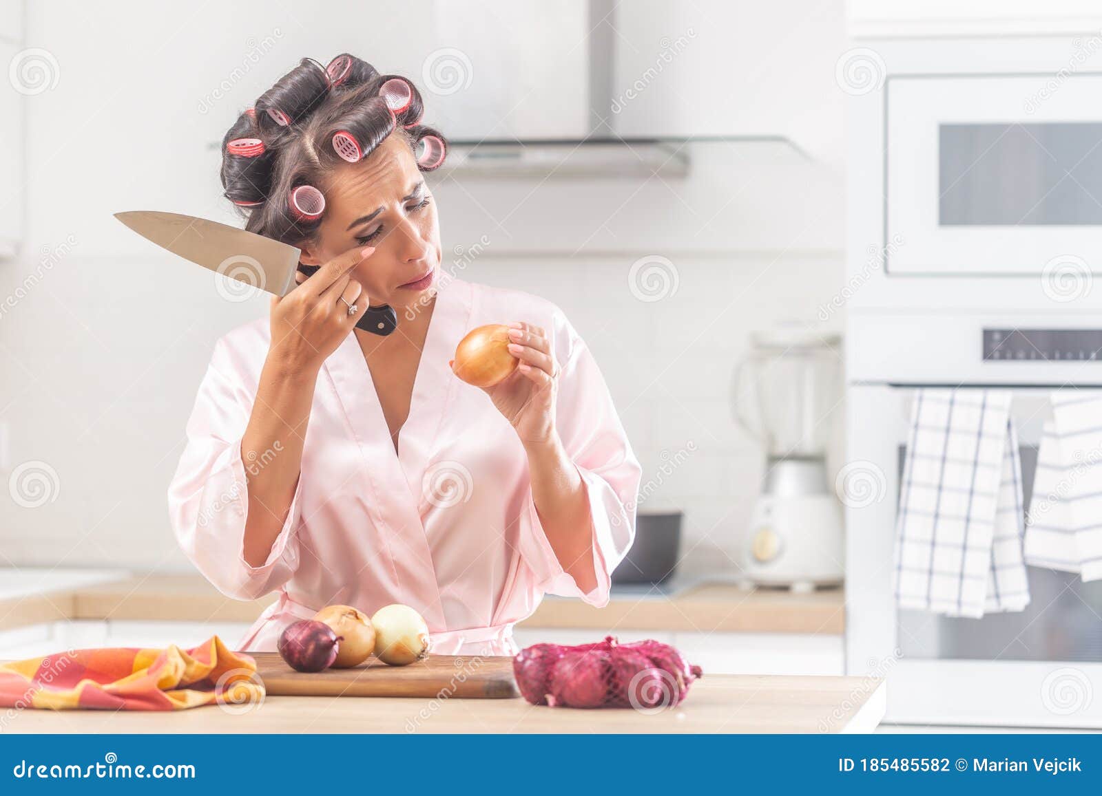 Girl Cries Over Onion Chopping in the Kitchen Wearing Head Curlers in ...