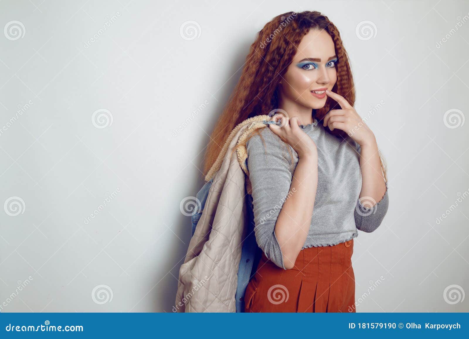 A with Curled Hair is Dancing, a Model in the Style of the 80s. 90s, with Bright Blue Make-up and a Jacket. the Stock - Image of model, party: