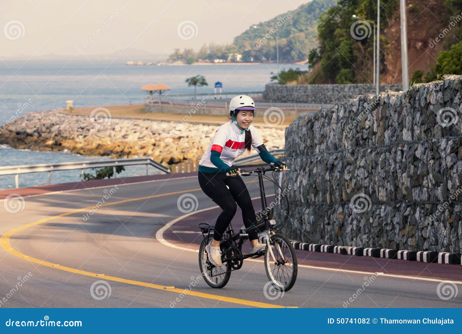 The Girl Cycling Uphill On The Road Stock Photo Image 50741082 throughout Cycling Uphill