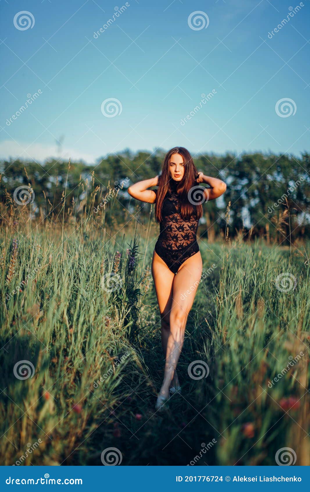 Cute Brunette Female Model Posing, Wearing Black One Piece Underwear Suit,  Touching Her Hair Stock Photo, Picture and Royalty Free Image. Image  93049577.
