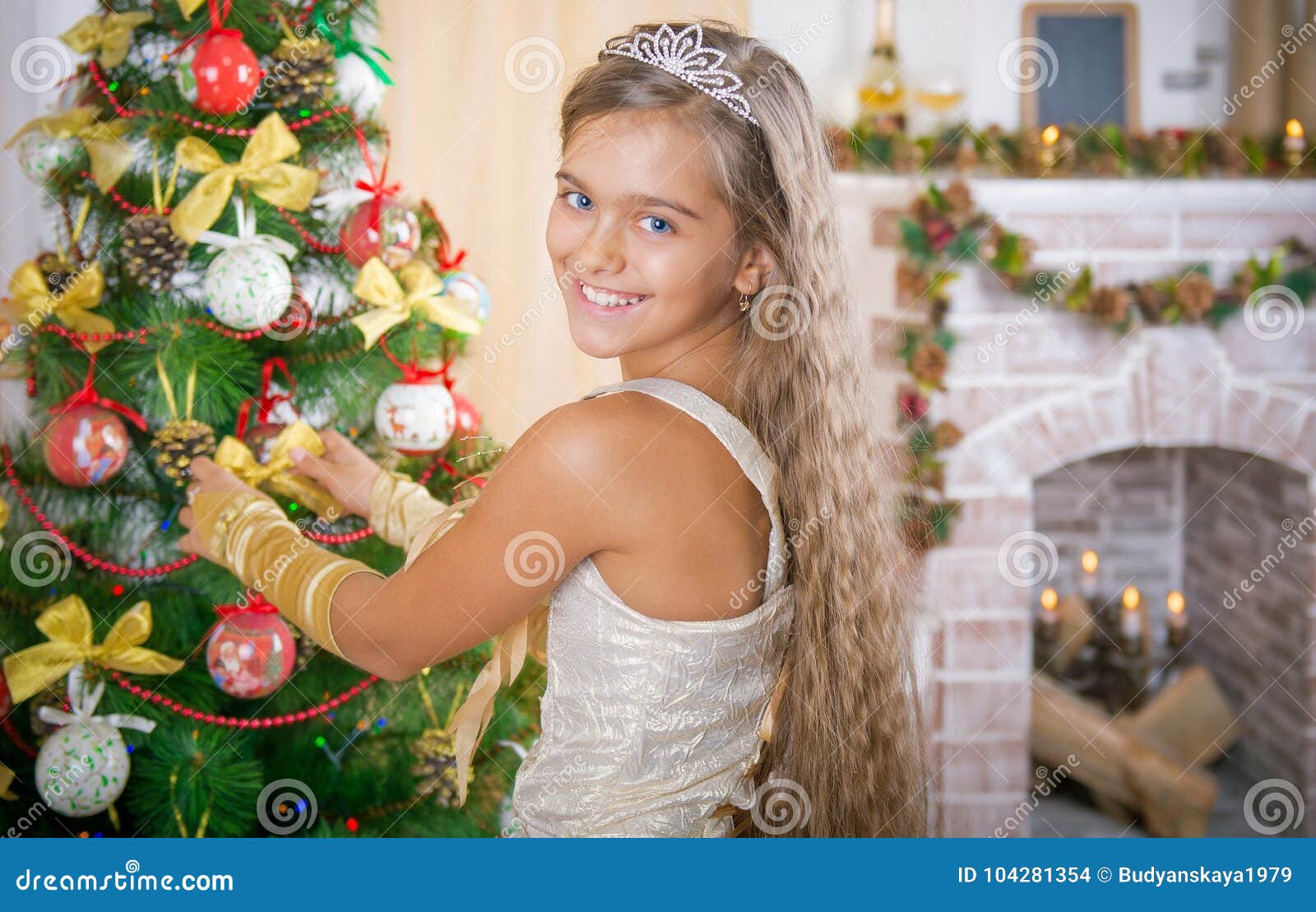 girl decorates christmas tree