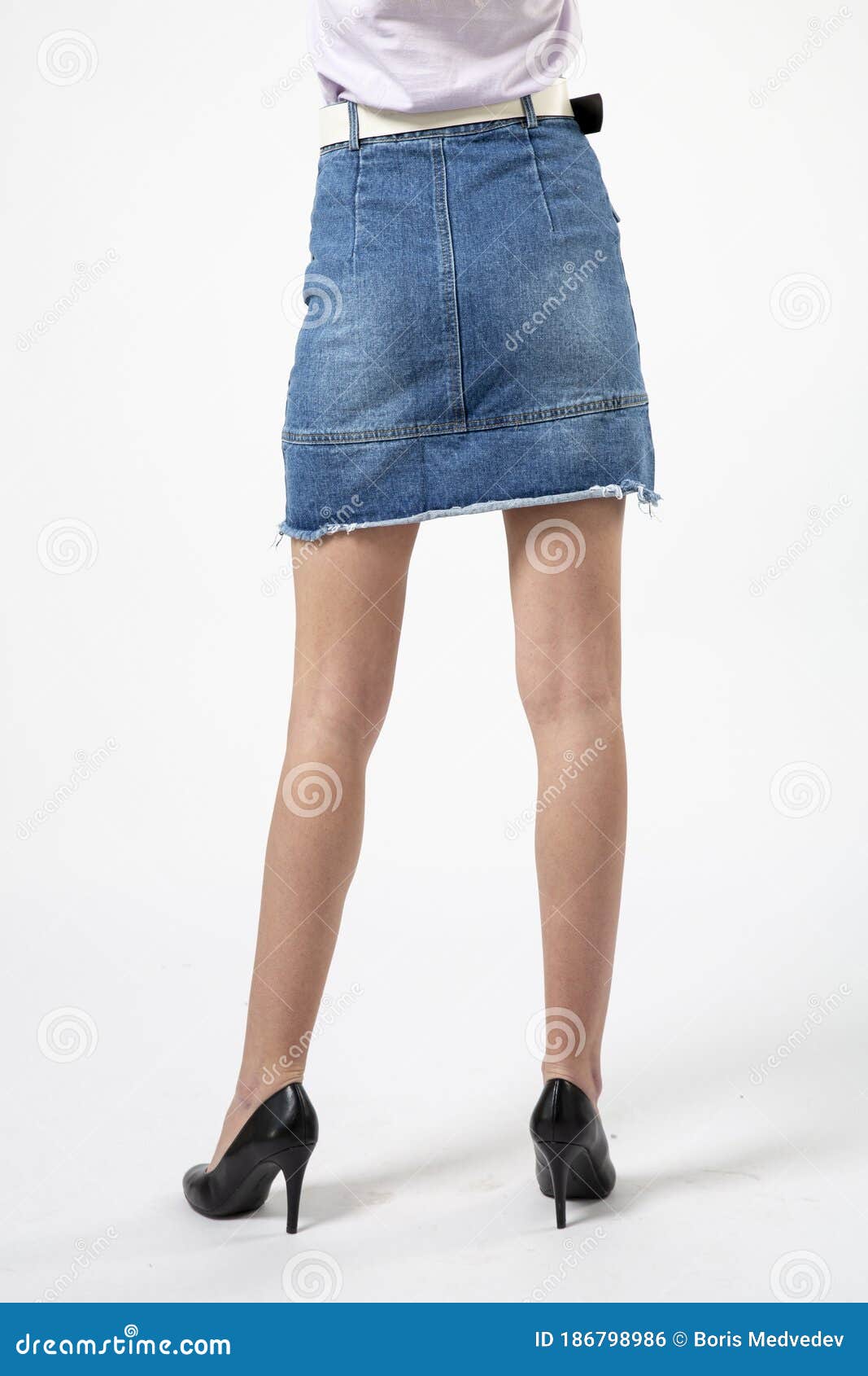 Girl In A Denim Short Skirt And High Heels Stock Photo - Image of legs ...