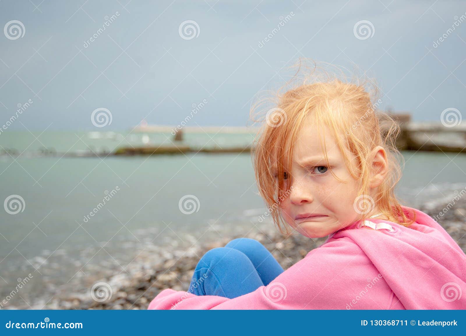 The Girl With A Displeased Facial Expression On The Beach Stock Image