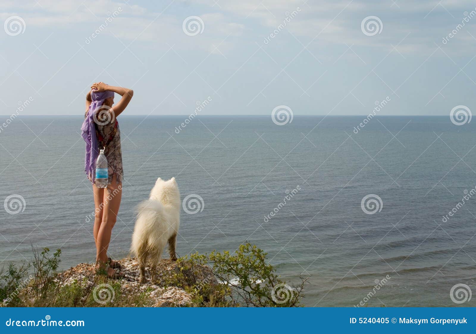 girl and dog standing on precipice