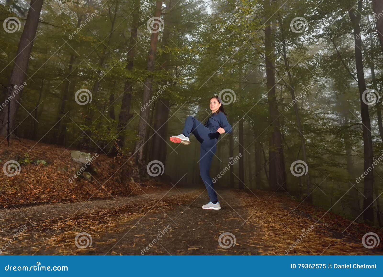 Girl Doing Knee Kick Exercise during Kickboxing Training in a Mi Stock