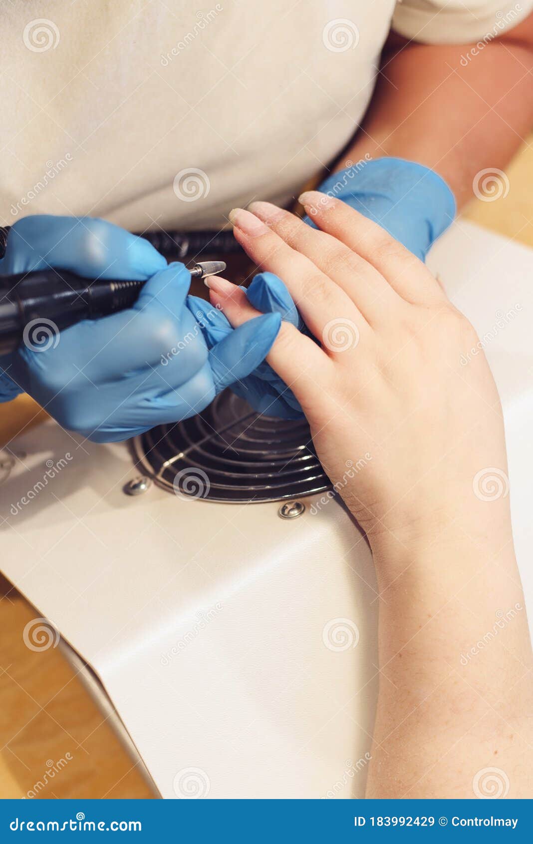 a girl is doing manicure. a girl is cutting nails