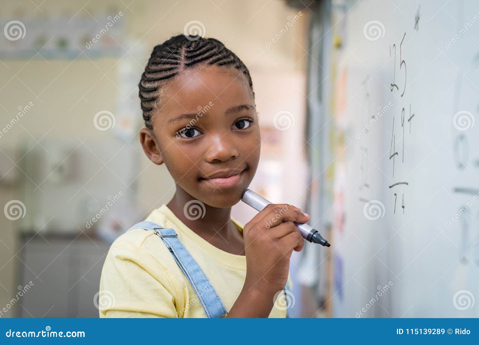 girl doing math at whiteboard