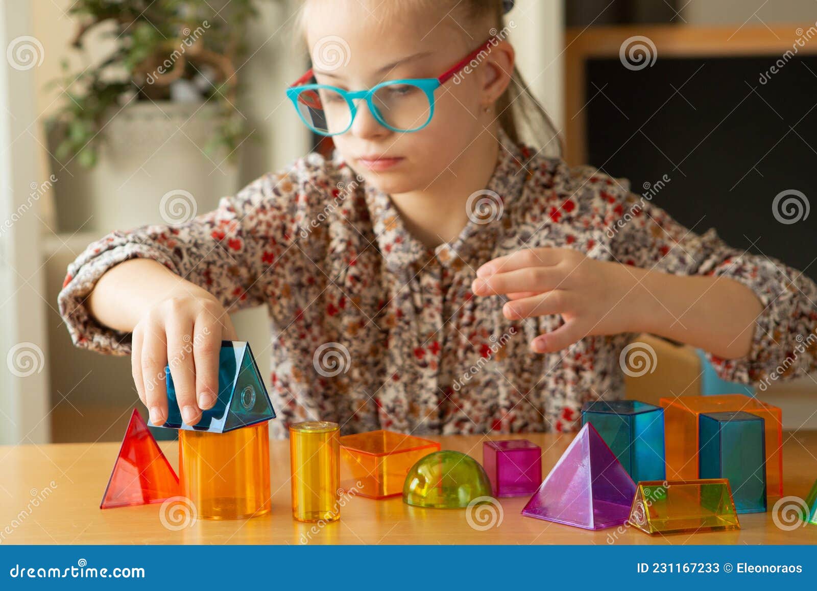 Girl with Down Syndrome Playing with Geometrical Shapes Stock Image