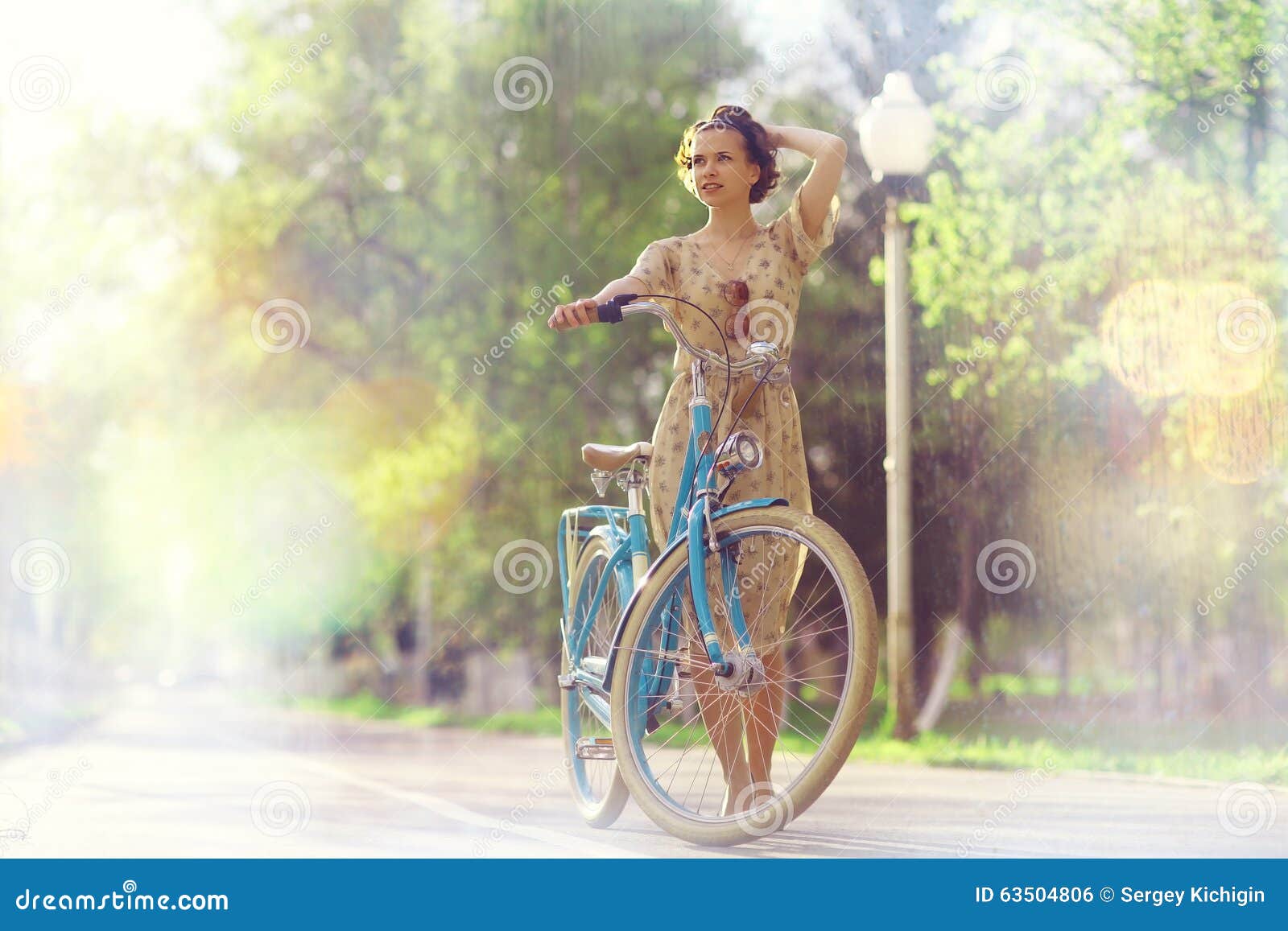 Girl in dress with bicycle stock photo. Image of city 63504806