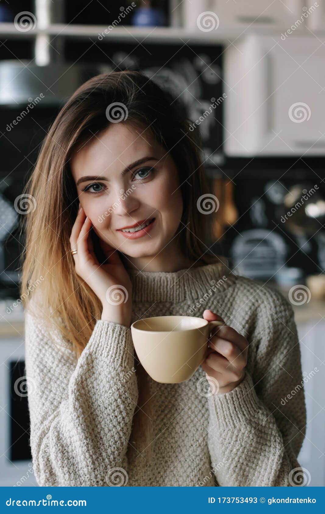 A Girl Drinking Coffee in the Kitchen at Home. Young Woman Holding Cup ...
