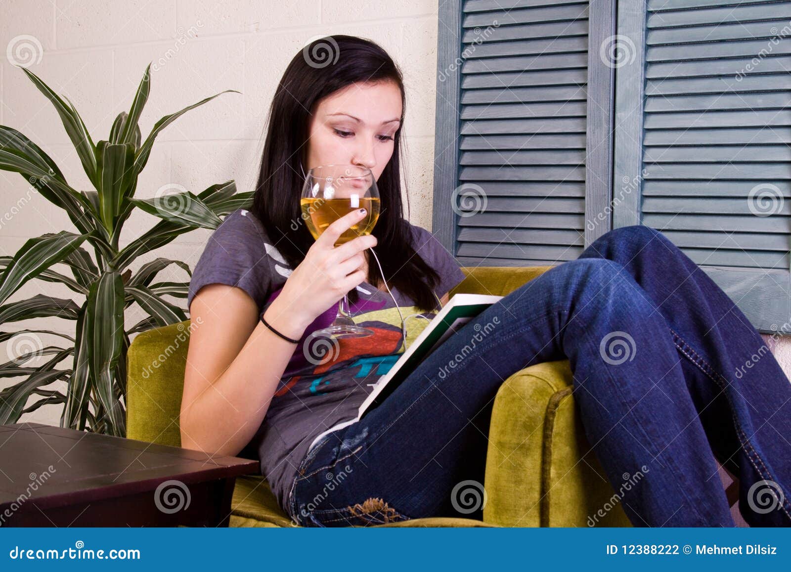 Girl Drinking while Reading a Book Stock Photo Image of listening