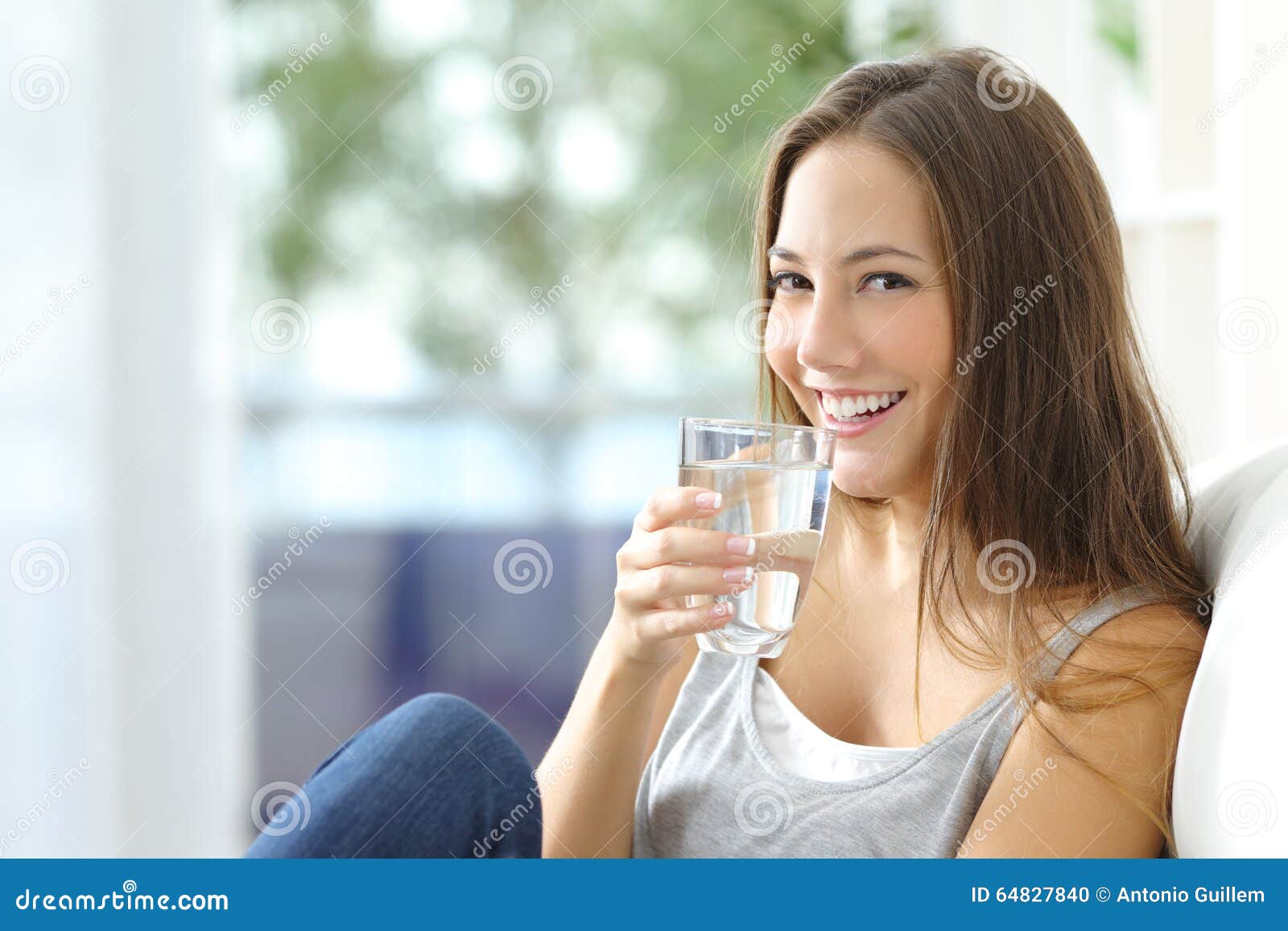 girl drinking water at home