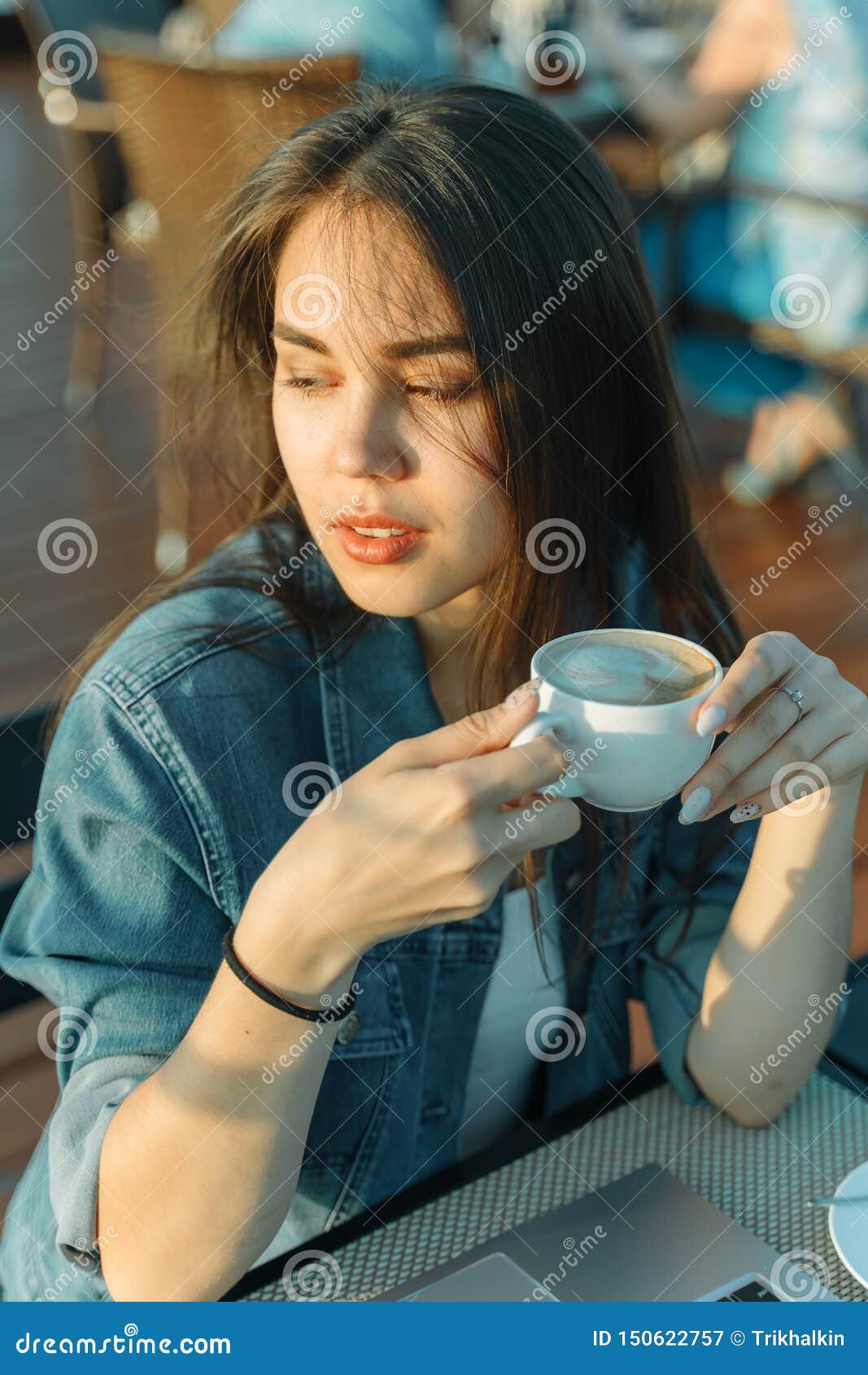 The Girl Drinks Coffee. Girl Blogger with a Cup of Coffee in an Outdoor ...